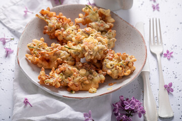 Sweet fried lilac flower in oil. Summer snack.