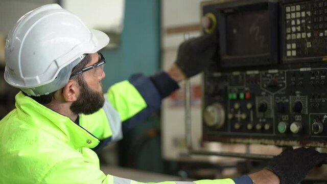 technician Engineer inspecting and controlling and operate heavy machine in the industrial plant  . factory worker maintenance control panels of machinery in production line