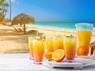 Glasses of tasty tequila sunrise cocktail on table at tropical resort