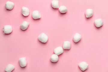 Soft cotton wool balls on color background