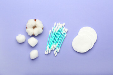 Fototapeta na wymiar Cotton swabs, pads and balls on color background