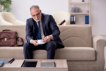 Old businessman employee waiting for business meeting