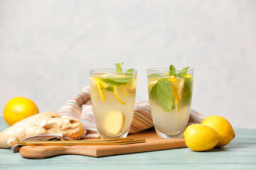 Glasses of cold ginger lemonade on table