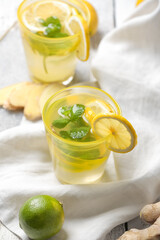 Glass of cold ginger lemonade on table