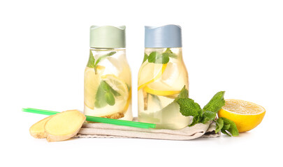 Bottles of cold ginger lemonade on white background