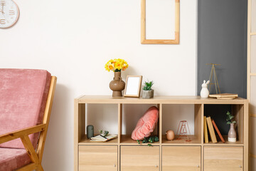 Shelving unit with stylish decor in modern interior of room