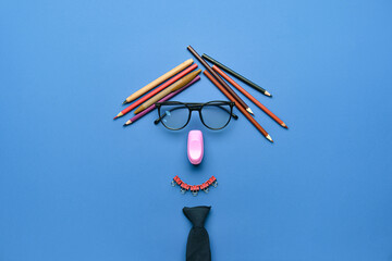 Teacher made of stationery on color background