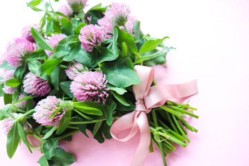 postcard mockup. bouquet of pink clovers on a white background and space for text 