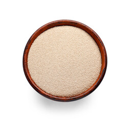 Bowl with active dry yeast on white background