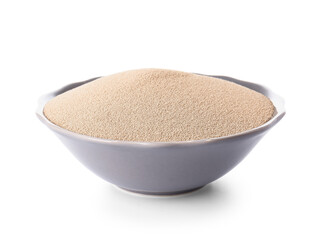 Bowl with active dry yeast on white background