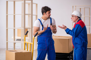 Two male professional movers doing home relocation