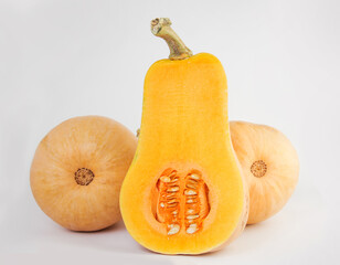 Three pumpkin pear-shaped on a light background.