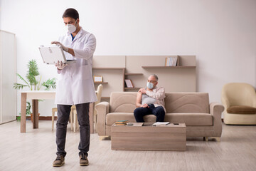 Young male doctor visiting old patient in vaccination concept