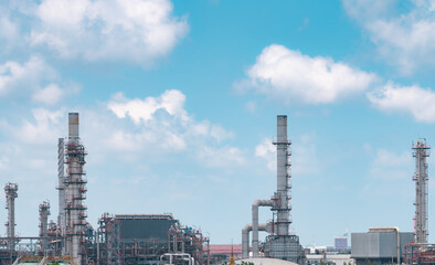 Oil refinery or petroleum refinery plant with blue sky background. Power and energy industry. Oil and gas production plant. Petrochemical industry. Natural gas storage tank. Petroleum business.