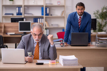 Fototapeta premium Old male boss and young male employee in remuneration concept