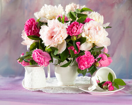 Still life with white and pink peonies in a vase