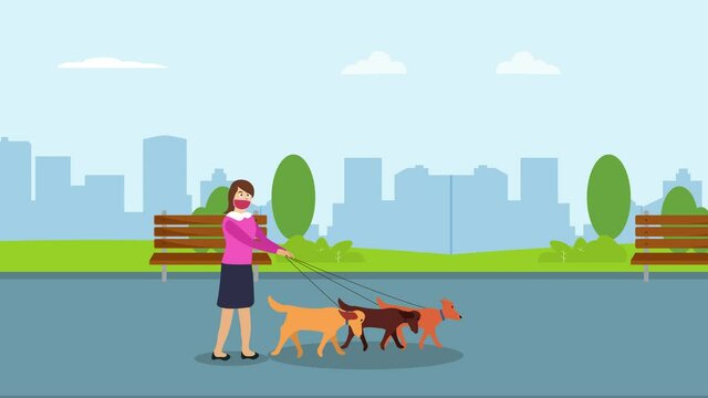 Young woman walking in the park with her dogs
