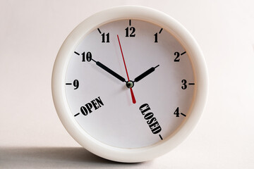 Sign design for a shop or office, opening and closing times in the form of a wall clock.