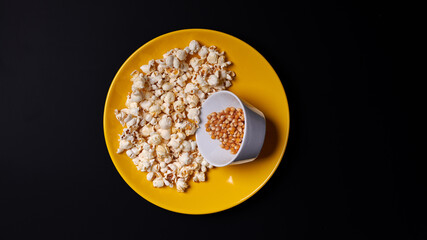 Group of yellow raw corn kernels sweet corn on plate. Popcorn Transformation.