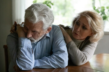 Supportive mature Caucasian woman hug comfort unhappy old husband feeling bad unhealthy. Caring...