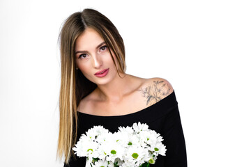 beautiful girl with a bouquet of flowers in a black jumpsuit bodysuit on a white background