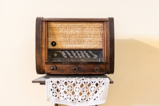Vejer de la Frontera, C&aacute;diz, Spain - June 14, 2021: Telefunken Vintage  tube radio tuner located on a wooden shelf and a cloth made of crochet