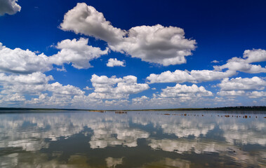 Large white clouds are reflected in the salt water of the Kuyalnitsky estuary, Ukraine.