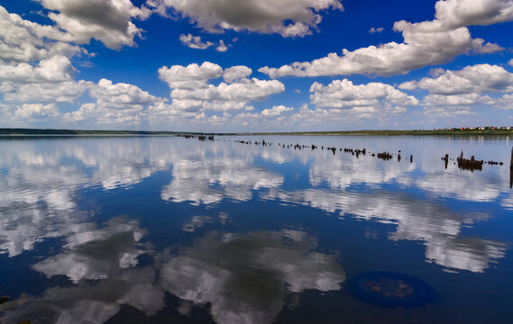 Large white clouds are reflected in the salt water of the Kuyalnitsky estuary, Ukraine. © Oleg Kovtun