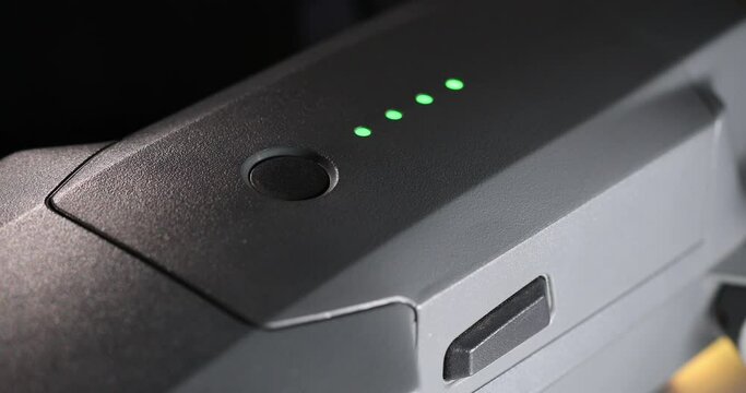 The male finger turns the drone on and then off by pressing a button. Trial activation. High quality 4k footage