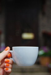 White cup with a hot drink on the background of a cozy restaurant. 