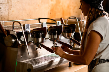 View of professional espresso machine and barista preparing deliciouse fresh hot coffee drink