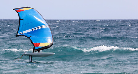 rider on a wind foil board, surf the waves