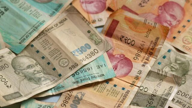 100 or 200 and 500 rupees and 2,000 rupees,Background of paper Indian money,growth in money,new Indian Paper currency