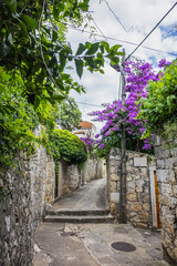 Fototapeta na wymiar Picturesque old stone narrow street in Cavtat. Cavtat - coastal town in the southern Konavle region of Croatia, just 20 kilometers away from Dubrovnik.