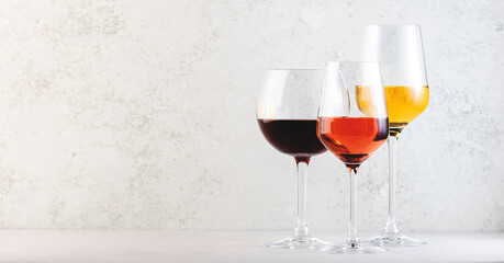 Wines assortment. Red, white, rose wine in wineglasses on gray background. Wine bar, shop, tasting concept
