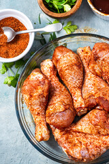 Raw Chicken Drumsticks Legs Marinating in Herbs and Hot Spices for BBQ Grill