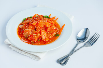 Salmon salad in a plate placed on a white background