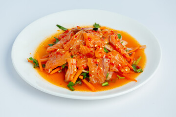 Salmon salad in a plate placed on a white background