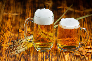 A glass of beer is placed on the wooden floor.