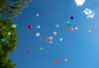 balls of different colors on blue sky