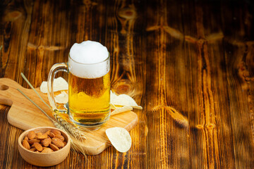 A glass of beer is placed on the wooden floor.