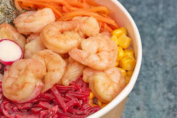 Close-up of shrimp poke with carrots, beets and seaweed.