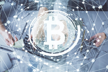 Double exposure of man and woman working together and crypto theme hologram drawing. Computer background. Blockchain concept. Top View.