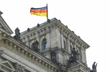 Fototapeta na wymiar Exterior of Reichstag building with Germany flag on top isolated on white background. No people.