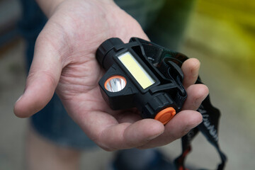 LED flashlight for wearing on the head. The lighting device is self-contained for different uses.