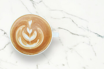 Cup of Cappuccino with Latte Art on White Marble Table Background, Top View with Copy Space