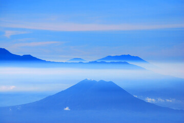 Fototapeta premium Rinjani Mountain Landscape and Cloude blue sky in the morning with fog and misty around the Valley. View from Bromo Mountain at Bromo tengger semeru national park , Indonesia - Blue Nature Abstract