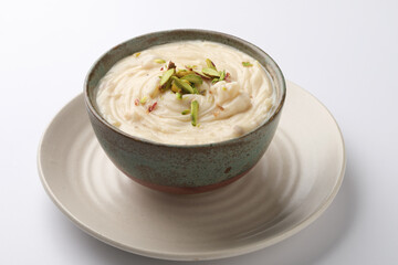 Shrikhand is an Indian sweet dish made of strained yogurt, garnished with dry fruits and saffron. 