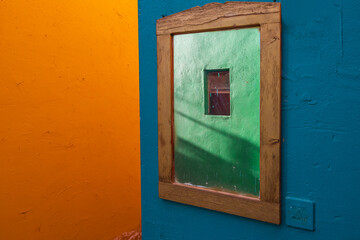 Abstraction, multi, colored walls and an old mirror, blue, green and orange.
