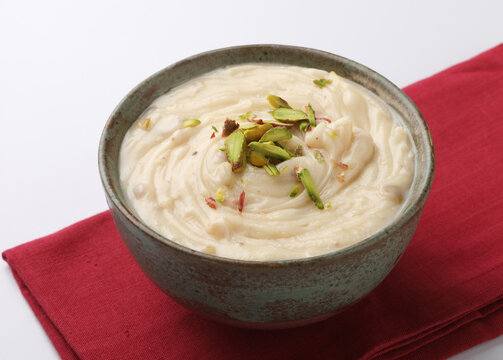 Shrikhand is an Indian sweet dish made of strained yogurt, garnished with dry fruits and saffron. 